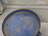 a blue plate sitting on the floor next to a toilet