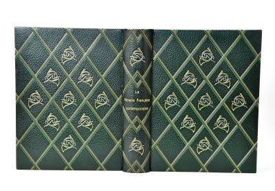 an old book with a green cover and gold designs on it