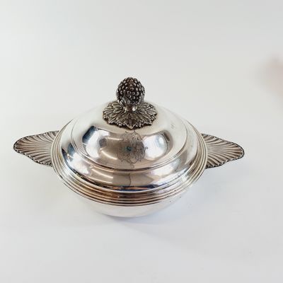 a silver plate with a bird on it
