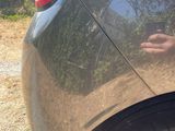 a man taking a picture of his reflection in the rear of a car