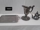 a silver tray with a silver teapot and a silver tray with a silver teapot and a silver tray with a silver teapot on it