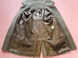 brown leather shorts on pink background with a tag on the side