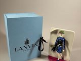 an image of a figurine of a woman in a blue dress in a blue box