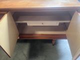 an image of a wooden desk with a drawer underneath it