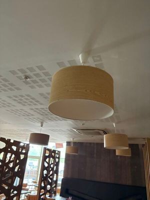 many lamps hanging from the ceiling in this restaurant