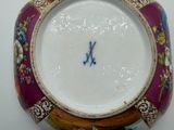 a close up of a colorful bowl with a monogram on it