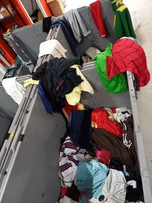 a large metal box filled with clothes and clothes