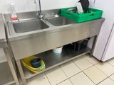 two sinks in the kitchen with a green basket on the counter