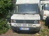 a white van that is parked in the dirt