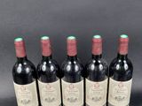 six bottles of red wine are lined up in a row