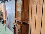 a grandfather clock that is in the corner of a room