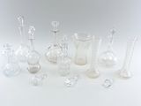 a lot of glass vases that are sitting on a table