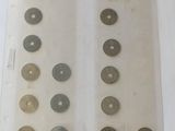 a lot of coins in a clear bag on a table