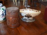 two vases and a bowl sitting on a table