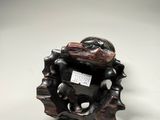 a small sculpture of a frog sitting on a tree branch