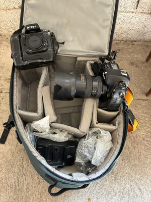 a camera and other items in a bag on the floor
