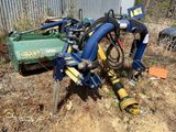 une machine bleue et jaune qui est posée dans l'herbe
