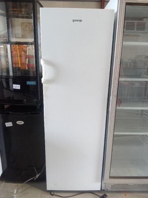 two refrigerators that are next to each other in a room