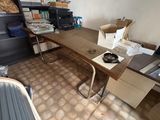 a desk in a room with a lot of boxes on it