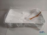 a plastic container with a wooden stick inside of it