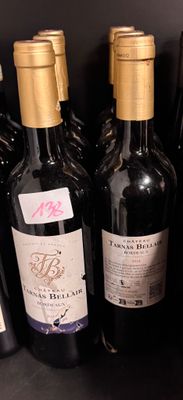 several bottles of wine are lined up on a shelf