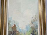 framed painting of a village scene with houses and trees in the foreground