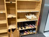a wooden shelf filled with bottles of wine and bottles of wine