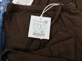 three pairs of brown and blue pants with tags on them