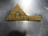 a close up of a metal plate with a sign on it