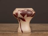 a vase with a flower on it sitting on a table