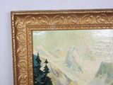 a painting of a mountain scene in a gold frame