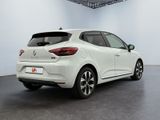 the rear end of a white car in a white room