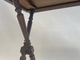a close up of a table with a wooden top and legs