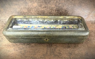 a metal box with a handle on it on the ground