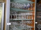 many glasses on the shelves in the room