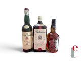 three bottles of liquor sitting next to each other on a table