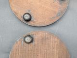 two pieces of wood with rivets and screws on them