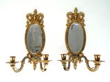 pair of antique brass wall sconces with mirrors and candle holders