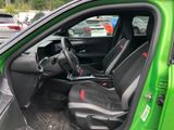 a green car with black seats in the back of it