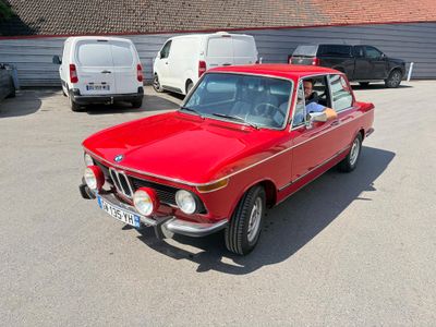 a red car that is parked in a parking lot