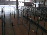 rows of empty tables in an empty warehouse with a lot of windows