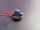 a ring with a blue stone sitting on top of a table