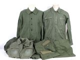 three military uniforms are displayed on a mannequin display