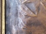 a picture of a bronze statue of a man with a sword