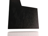 a black piece of paper on a white surface