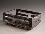 a glass box with a handle on a white surface