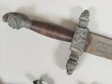 a close up of a knife on a white surface