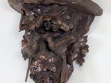 a wooden carving of a man with a hat on his head