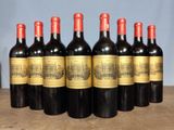 six bottles of wine are lined up on a table