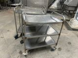 a metal cart with three trays on it